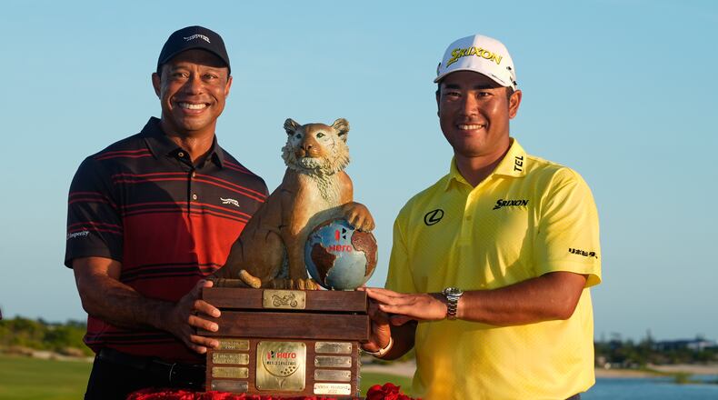 Hideki Matsuyama, of Japan, right, poses for a photo with golf legend Tiger Woods after winning the Hero World Challenge PGA Tour at the Albany Golf Club, in New Providence, Bahamas, Sunday, Dec. 7, 2025. (AP Photo/Fernando Llano)