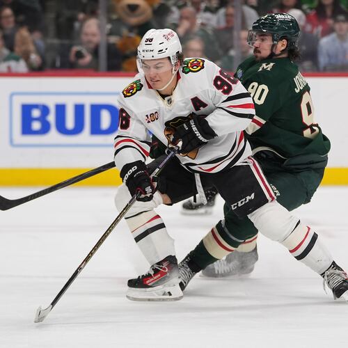 FILE - Chicago Blackhawks center Connor Bedard (98) skates with the puck as Minnesota Wild left wing Marcus Johansson (90) defends during the second period of an NHL hockey game, March 19, 2026, in St. Paul, Minn. (AP Photo/Abbie Parr, File)