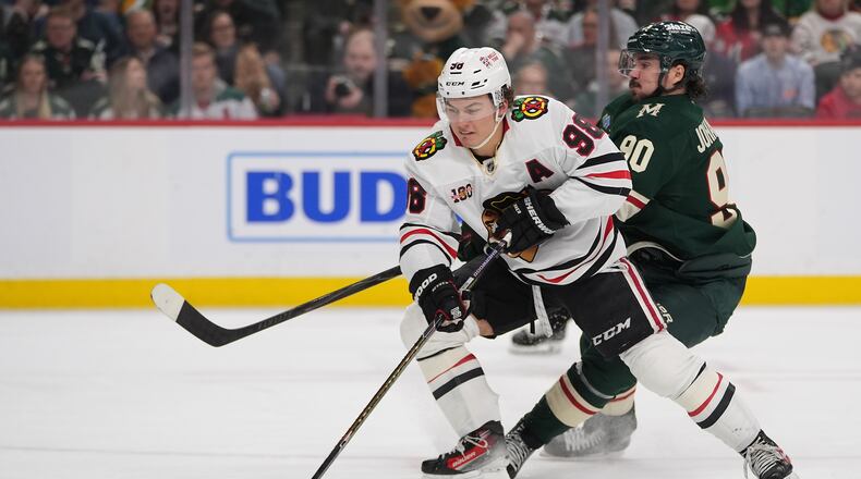 FILE - Chicago Blackhawks center Connor Bedard (98) skates with the puck as Minnesota Wild left wing Marcus Johansson (90) defends during the second period of an NHL hockey game, March 19, 2026, in St. Paul, Minn. (AP Photo/Abbie Parr, File)