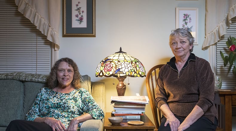 Roommates Beth Hogan (left) and Debbie Aschemeier sit recently for a photo at their residence in Mableton. Across the country, older individuals are becoming roommates to cut costs, and have companionship — just like in the old television show “The Golden Girls.” ALYSSA POINTER / ALYSSA.POINTER@AJC.COM