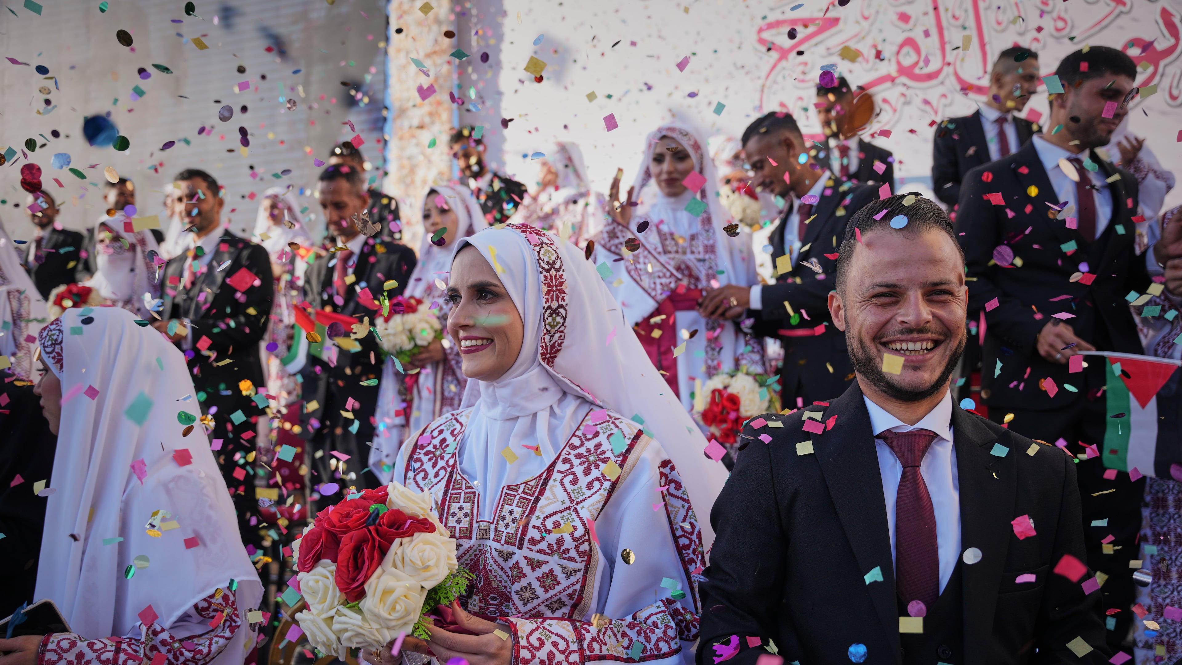 Palestinian couples participate in a mass wedding ceremony in Hamad City in Khan Younis, Gaza Strip, Tuesday, Dec. 2, 2025. (AP Photo/Abdel Kareem Hana)
