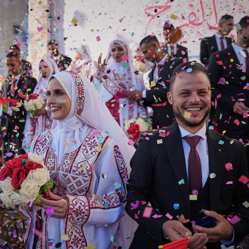 Palestinian couples participate in a mass wedding ceremony in Hamad City in Khan Younis, Gaza Strip, Tuesday, Dec. 2, 2025. (AP Photo/Abdel Kareem Hana)