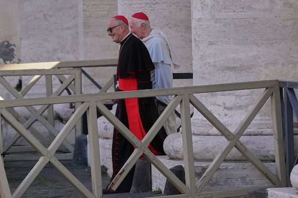 Cardinals walk in St. Peter's Square as they arrive for a meeting of cardinals, at the Vatican, Tuesday, April 22, 2025. (AP Photo/Andrew Medichini)