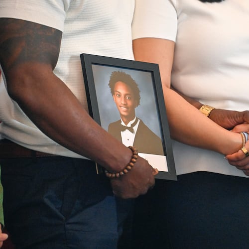 Christine Wonsley and Elmore Wonsley, mother and step father of Nolan Wells, stand on a stage with a photo of their son as they appear at the National Urban League's annual conference to share updates on his death, as well as Daniel Erving, and Tyler Smith, Thursday, July 30, 2026, in Nashville, Tenn. (AP Photo/John Amis)