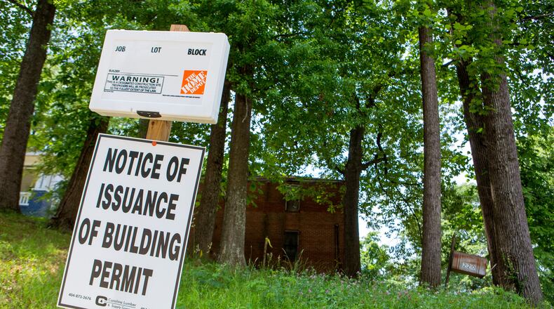 A building sign is seen in front of the childhood home of former Atlanta mayor Maynard Jackson at 220 Sunset Avenue NW in Atlanta, Ga., on Tuesday, May 7, 2019. The home, which has fallen into disrepair, was set to be demolished. Those plans have been placed on hold. (Casey Sykes for The Atlanta Journal-Constitution)