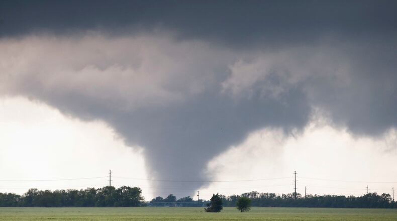 A large tornado passes just to the west of the city of Halstead, Kan., Wednesday, May 6, 2015. A swath of the Great Plains is under a tornado watch Wednesday, including parts of North Texas, Oklahoma, Kansas and Nebraska. (Travis Heying/The Wichita Eagle via AP)