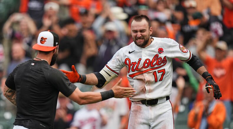 Baltimore Orioles' Colton Cowser, right, celebrates with teammates after hitting a walk off two-run home run during the 13th inning of a baseball game against the Tampa Bay Rays, Monday, May 25, 2026, in Baltimore. (AP Photo/Stephanie Scarbrough)