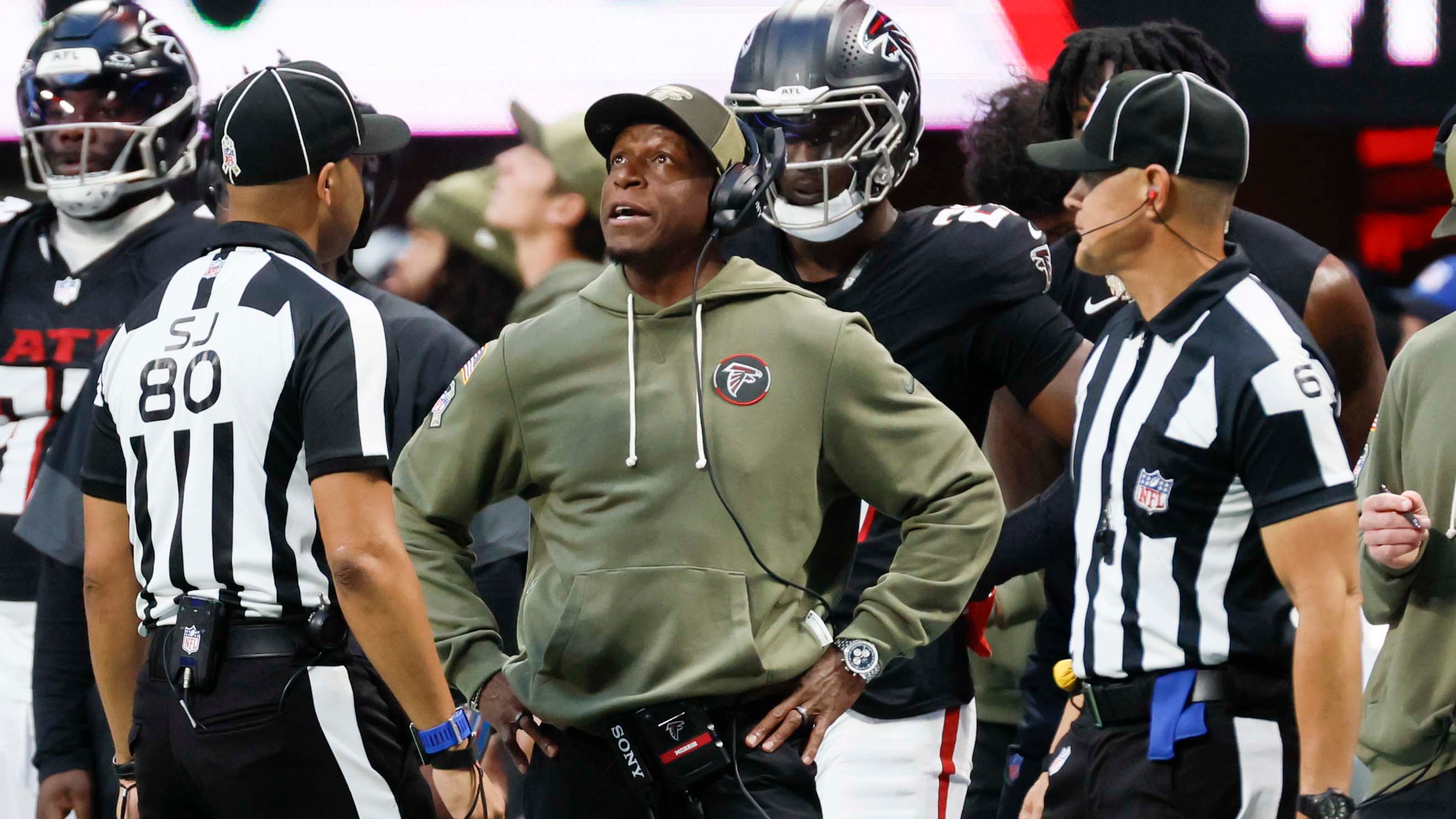 Falcons coach Raheem Morris (center) has a discussion with referees during the second half against the Panthers on Sunday, Nov. 16, 2025, at Mercedes-Benz Stadium in Atlanta. (Miguel Martinez/AJC)