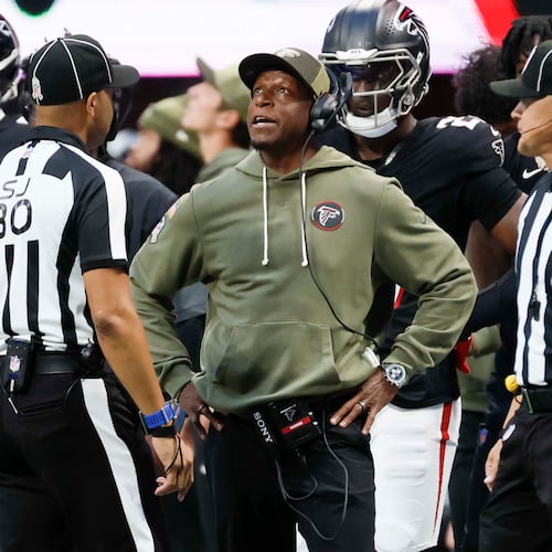 Falcons coach Raheem Morris (center) has a discussion with referees during the second half against the Panthers on Sunday, Nov. 16, 2025, at Mercedes-Benz Stadium in Atlanta. (Miguel Martinez/AJC)