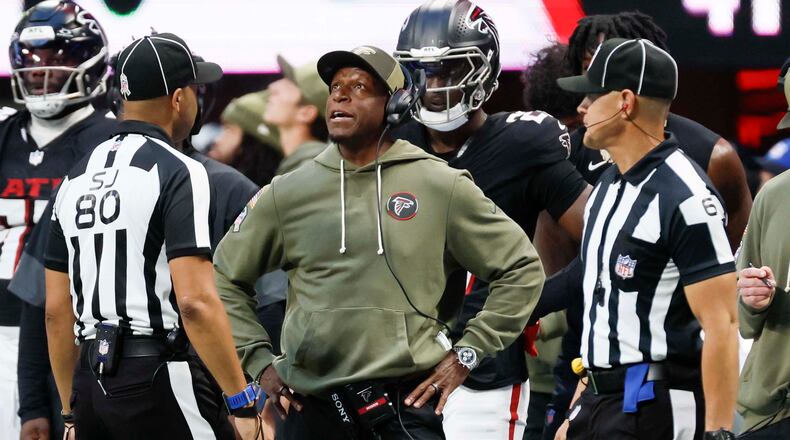 Falcons coach Raheem Morris (center) has a discussion with referees during the second half against the Panthers on Sunday, Nov. 16, 2025, at Mercedes-Benz Stadium in Atlanta. (Miguel Martinez/AJC)