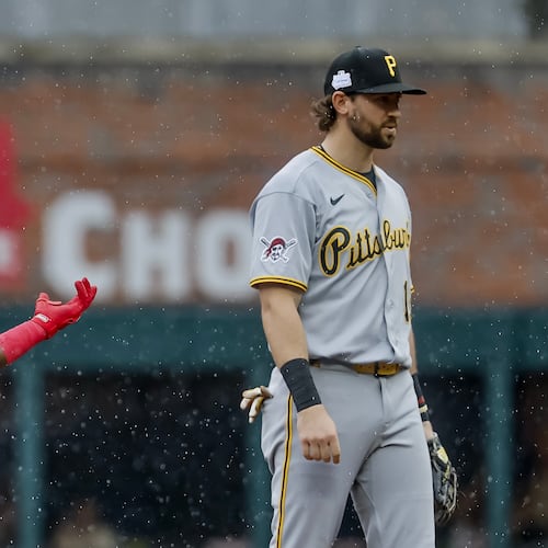 Atlanta Braves pinch hitter Michael Harris II, left, reacts after hitting a three-run double as Pittsburgh Pirates shortstop Jared Triolo, right, looks on during the seventh inning of a baseball game, Sunday, June 7, 2026, in Atlanta. (AP Photo/Erik S. Lesser)