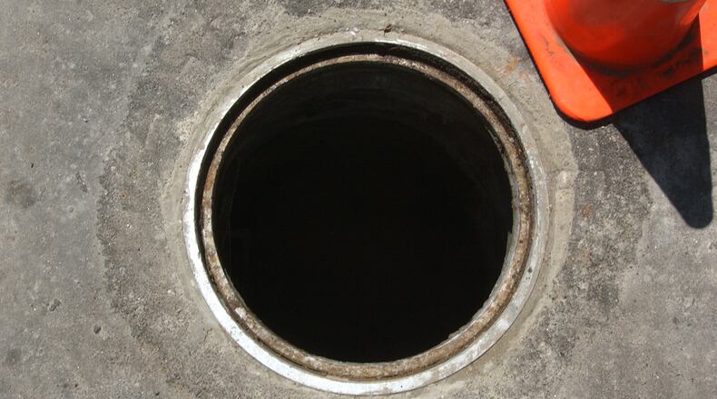 A City of Atlanta manhole without its cover. The cast iron manhole covers are a popular target for thieves who steal them and sell them for scrap.