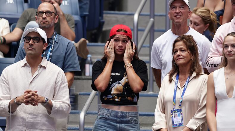 Soccer player Trinity Rodman, center, reacts after her boyfriend Ben Shelton, of the United States, lost the men's singles final of the U.S. Open tennis championships against Alexander Zverev, of Germany, Sunday, Sept. 13, 2026, in New York. (AP Photo/Adam Hunger)