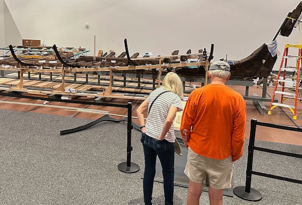 Visitors to the New York State Museum view a Revolutionary War-era gunboat that is being partially reconstructed, Friday, May 30, 2025, in Albany, New York. (AP Photo/Michael Hill)