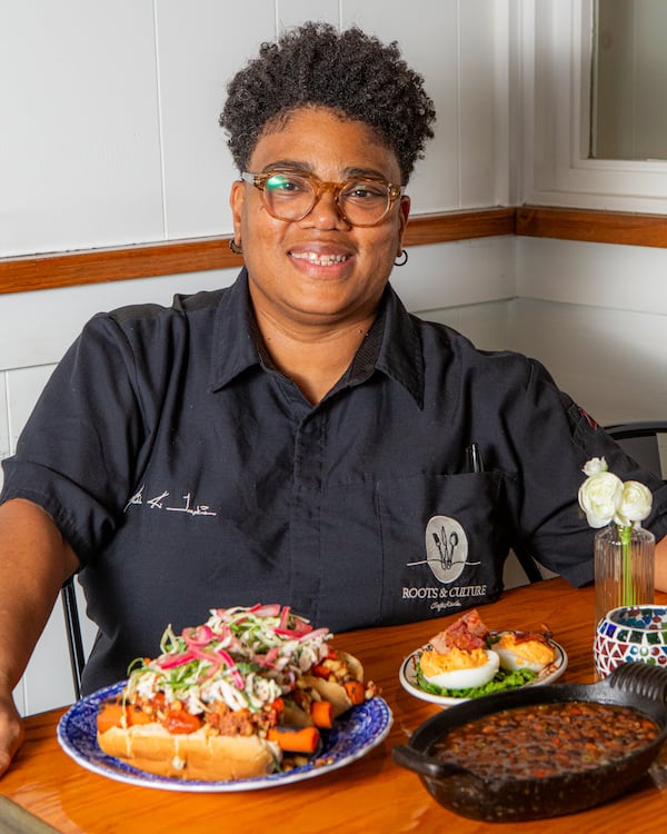 Local chef Michele Tompkins shown with dishes she created for readers' Labor Day menus. Tompkins' recipes are influenced by global flavors and food from her family's island roots. (Aaliyah Man for the AJC/food styling by Michele Tompkins)