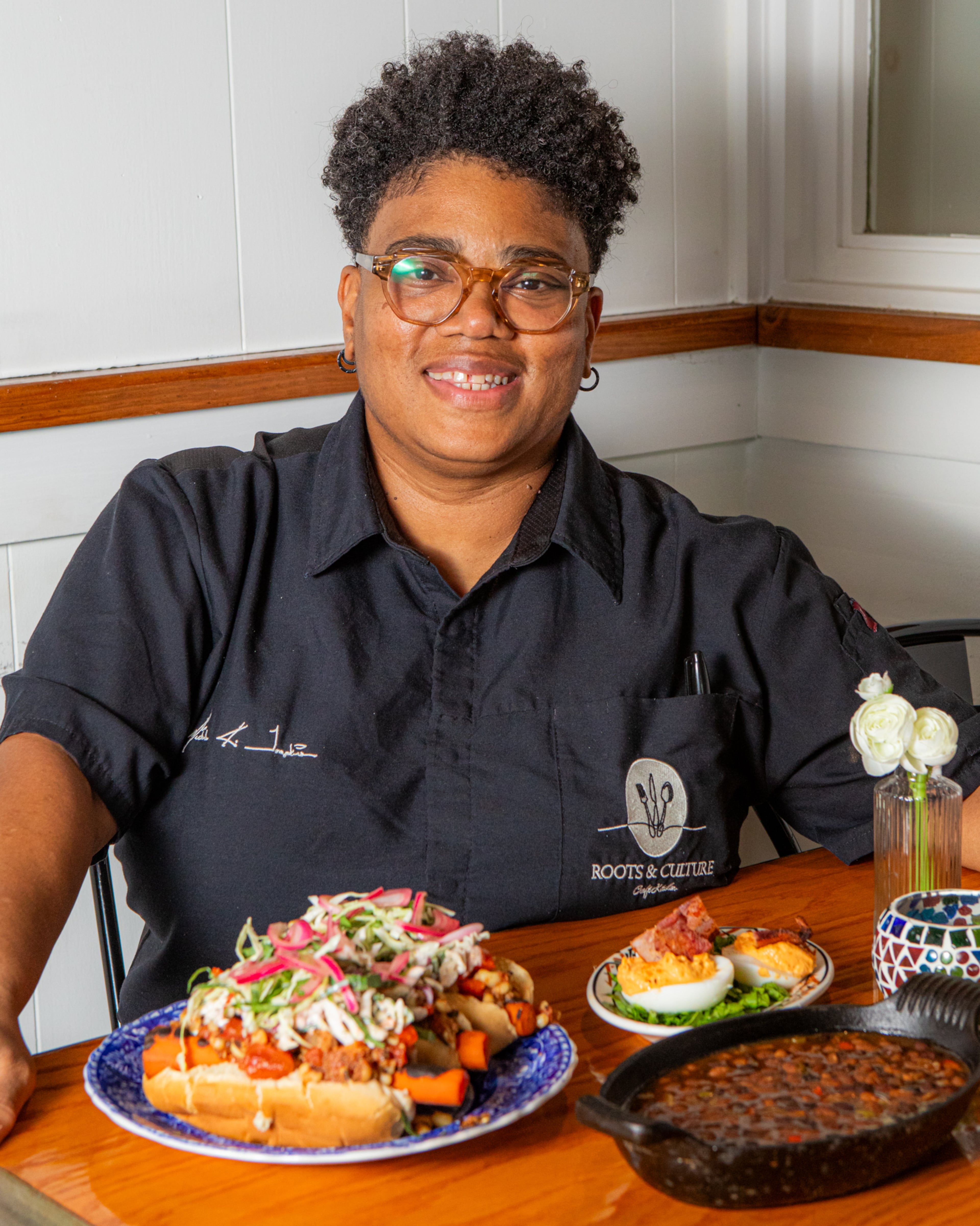 Local chef Michele Tompkins shown with dishes she created for readers' Labor Day menus. Tompkins' recipes are influenced by global flavors and food from her family's island roots. (Aaliyah Man for the AJC/food styling by Michele Tompkins)