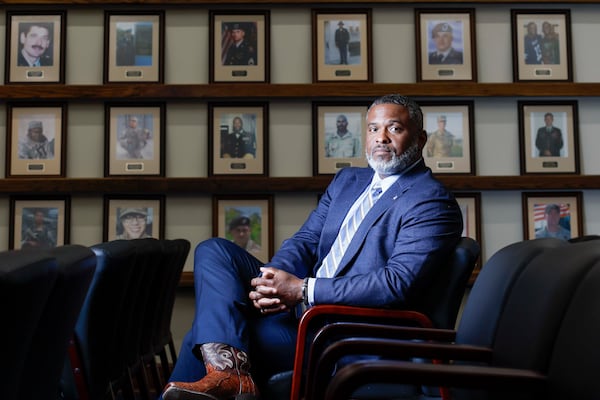 Alonzo Stewart, the Survivor Outreach Service coordinator at Georgia's Fort Benning, sits in the Hall of Heroes room on Wednesday, May 13, 2026. Stewart’s role with the SOS program involves providing long-term support, resources, and counseling to families of fallen soldiers. (Miguel Martinez/AJC)