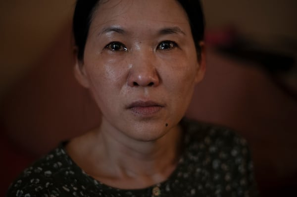 FILE - Yooree Kim, who was 11 when she was sent by an adoption agency to a couple in France, sits for a portrait as tears well up in her eyes in her apartment in Seoul, South Korea, Sunday, May 19, 2024. (AP Photo/Jae C. Hong, File)