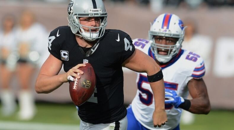 The Oakland Raiders' Derek Carr (4) rolls out against the Buffalo Bills on Sunday, Dec. 4, 2016, at the Oakland Coliseum in Oakland, Calif. (Dan Honda/Bay Area News Group/TNS)