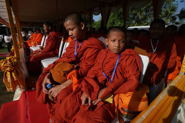 Cambodian Buddhist monks attend a ceremony during an annual ceremony of Remembrance Day at Choeung Ek, a former Khmer Rouge "killing field," on the outskirt of Phnom Penh, Cambodia Tuesday, May 20, 2025. (AP Photo/Heng Sinith)