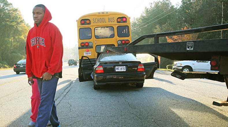 The driver of a Honda who refused to be identified (left) was uninjured, as was a Cobb County bus driver, when the Honda rear-ended the school bus in 2010. The Honda driver was charged with following too closely. No students had yet boarded the bus. (John Spink/AJC 2010)