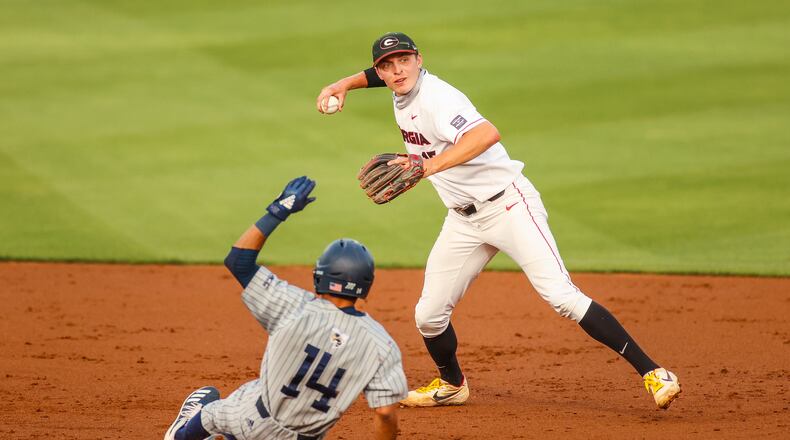 Georgia shortstop Cole Tate (15) gets the first out in an attempted double play as Georgia Tech's Austin Wilhite slides nto second base at Foley Field in Athens on Tuesday, April 27, 2021. (Photo by Tony Walsh/UGA Athletics)