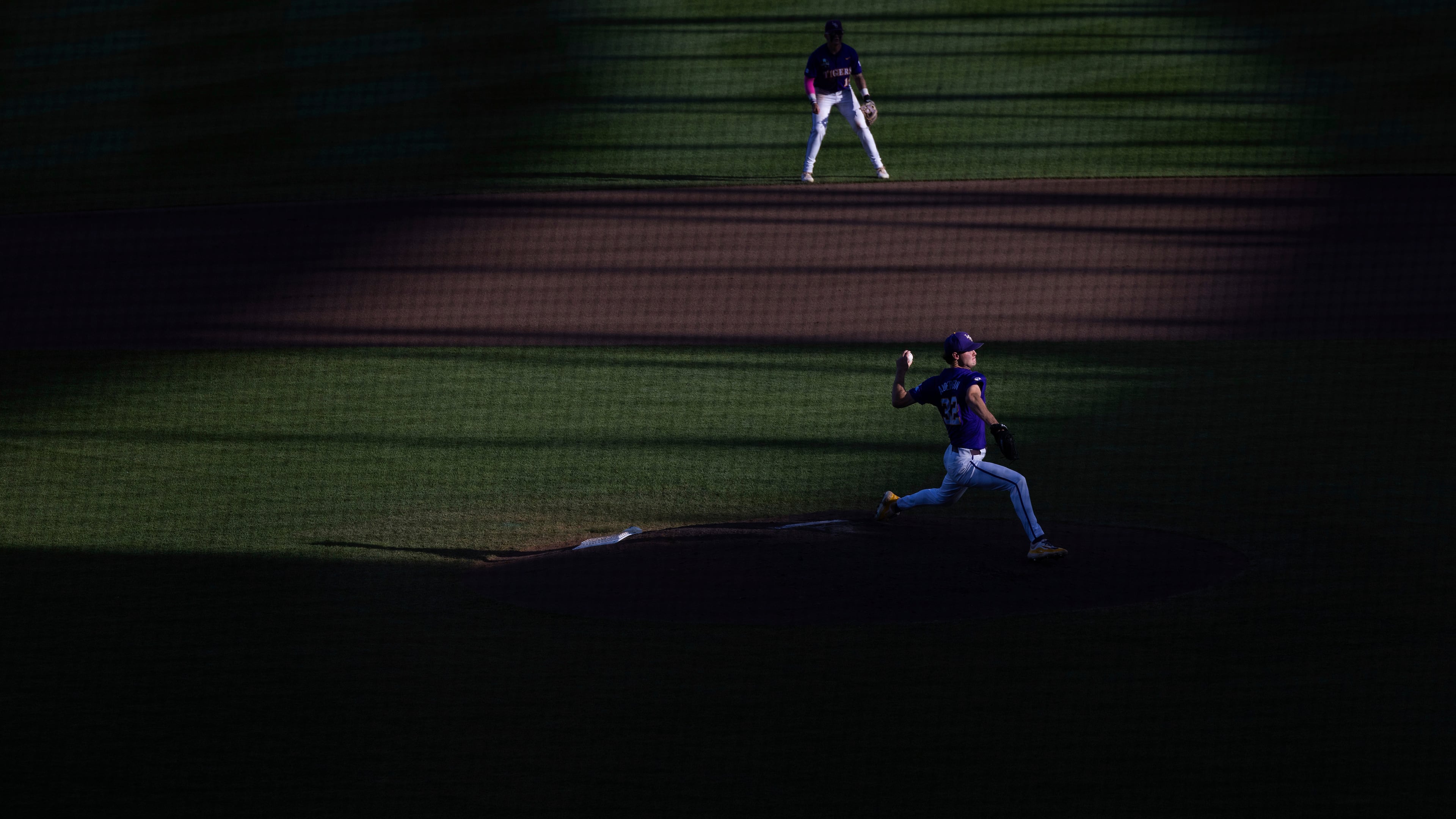 FILE - LSU starting pitcher Kade Anderson, bottom, throws against Coastal Carolina in the fourth inning of Game 1 of the NCAA College World Series baseball finals in Omaha, Neb., Saturday, June 21, 2025. (AP Photo/Rebecca S. Gratz, File)