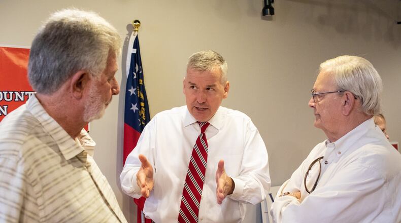 U.S. Rep. Rob Woodall, center, discusses the issues with constituents during a campaign event earlier this year. (CREDIT: Dustin Chambers)