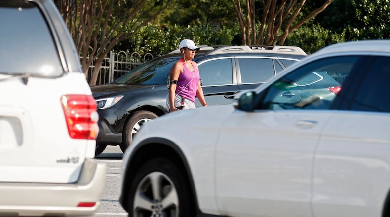 A pedestrian crosses the Mt. Vernon and Chamblee Dunwoody Road intersection in Dunwoody. (Photo: Bob Andres / robert.andres@ajc.com)
