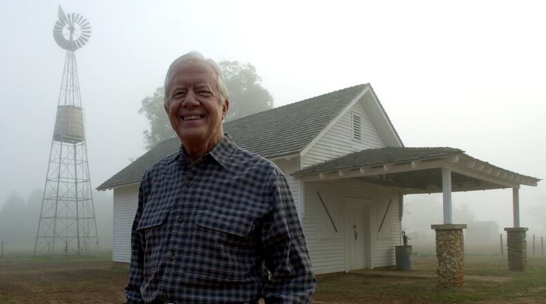 President Jimmy Carter looks over the site of his boyhood home and farm as a bank of fog lifts at day break near Plains, Ga., on Monday, Oct. 30, 2000. (CURTIS COMPTON/staff)