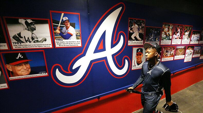 Passing images of the Braves past, outfield prospect Ronald Acuna goes to work on the future at the Braves spring camp. (Curtis Compton/ccompton@ajc.com)
