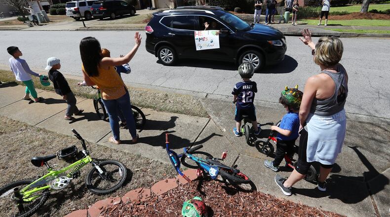 Suwanee moms and students turn out for their teachers from Roberts Elementary School while they hold an inspirational school parade driving through area neighborhoods for some face-to-face contact while still maintaining social distance to ease the separation anxiety of their students during the coronavirus outbreak on Wednesday, March 25, 2020. Curtis Compton ccompton@ajc.com