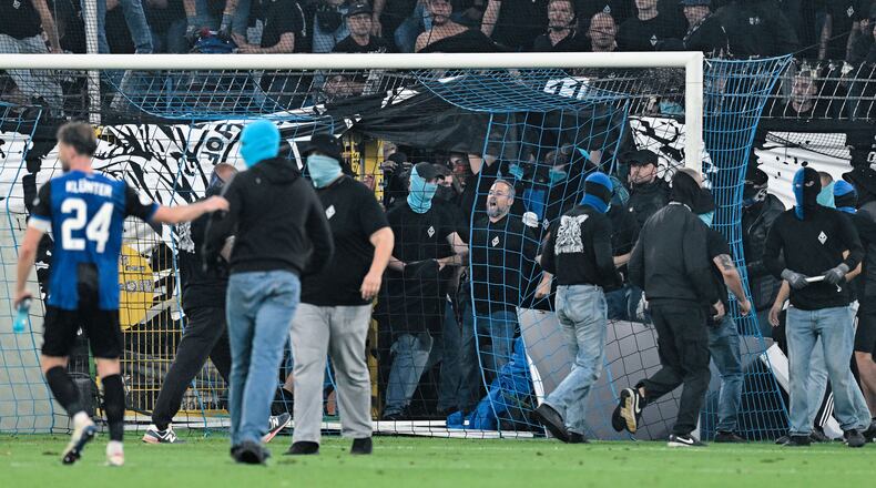 SV Mannheim supporters storm the field during the Germany Cup soccer match between SV Waldhof Mannheim and 1. FC Kaiserslautern, Friday, Aug. 21, 2026, in Mannheim, Germany. (Uwe Anspach/dpa via AP)