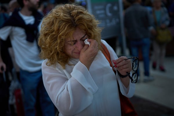 Paquita Gonzalez cries as she waits for news of train departures, after spending the whole night at the station Sants station in Barcelona, Spain, Tuesday, April 29, 2025. (AP Photo/Emilio Morenatti)
