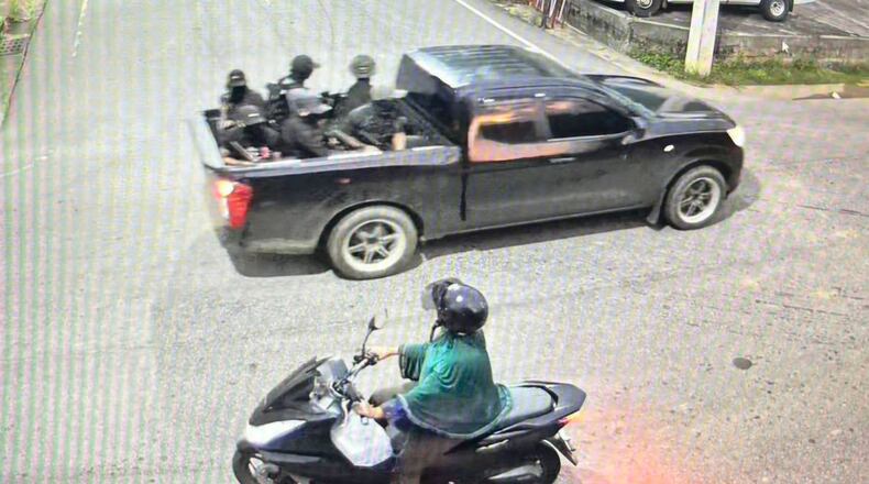 This image taken from video provided by Internal Security Operations Command Region 4 shows a group of the alleged attackers riding on a back of a black pickup truck before they opened fire and threw pipe bombs at soldiers at a security checkpoint in Narathiwat province, Thailand, Wednesday, July 22, 2026. (Internal Security Operations Command Region 4 via AP)