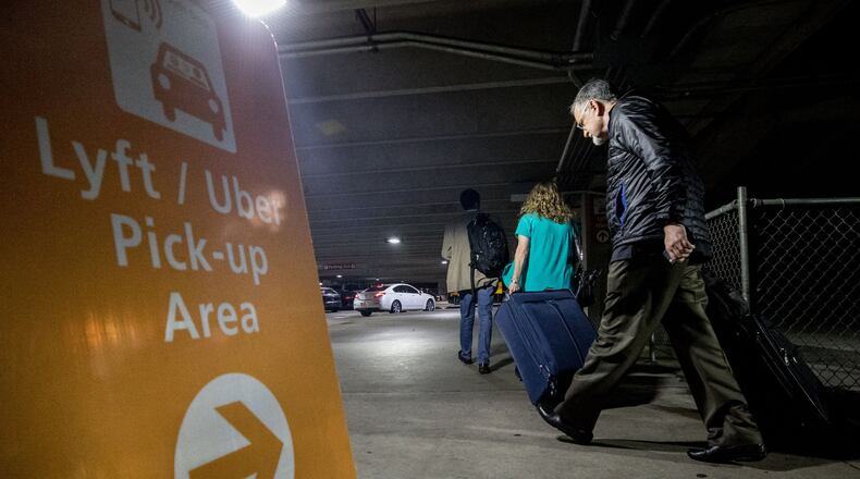 Passengers make their way to the Rideshare location at Hartsfield-Jackson International Airport, Thursday, Nov. 9, 2017, in Atlanta. BRANDEN CAMP/SPECIAL