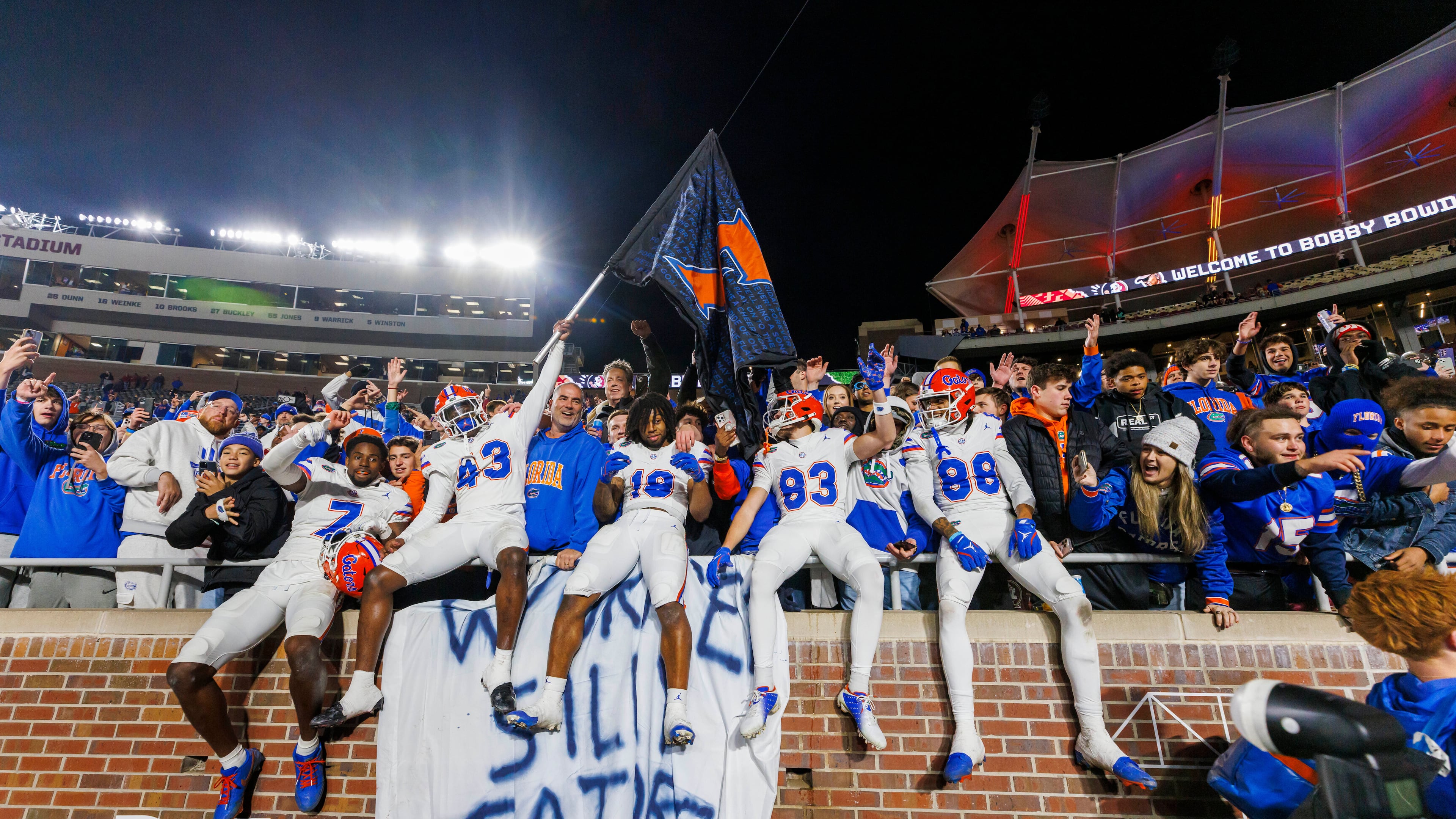 FILE -Florida players and fans celebrate after defeating Florida State in an NCAA college football game, Nov. 30, 2024, in Tallahassee, Fla. (AP Photo/Colin Hackley, File)