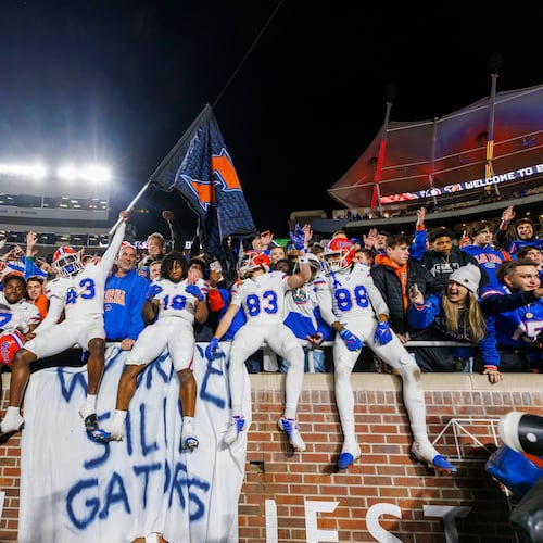 FILE -Florida players and fans celebrate after defeating Florida State in an NCAA college football game, Nov. 30, 2024, in Tallahassee, Fla. (AP Photo/Colin Hackley, File)