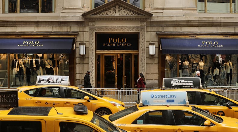 NEW YORK, NY - APRIL 04: People walk by Ralph Lauren's Fifth Avenue Polo store on April 4, 2017 in New York City. The luxury brand announced on Tuesday that it will close the exclusive location, just doors down from Trump Tower. The iconic clothing company has struggled financially as more shoppers migrate to online shopping among other consumer challenges. (Photo by Spencer Platt/Getty Images)