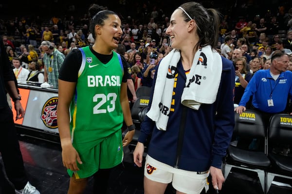Brazil guard Izabela Leite (23) talks with Indiana Fever guard Caitlin Clark, center right, after an exhibition women's basketball game, Sunday, May 4, 2025, in Iowa City, Iowa. (AP Photo/Charlie Neibergall)