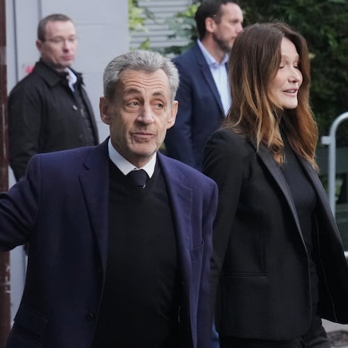 Former French President Nicolas Sarkozy and his wife Carla Bruni-Sarkozy leave their home Tuesday, Oct. 21, 2025 in Paris as Nicolas Sarkozy heads to prison to serve time for a criminal conspiracy to finance his 2007 election campaign with funds from Libya. (AP Photo/Thibault Camus)
