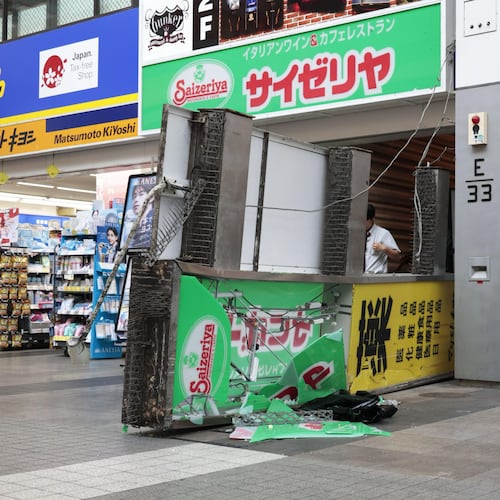 A store sign of a restaurant is seen fallen on the ground after an earthquake in Kumamoto in the Kyushu island, southern Japan, Tuesday, July 28, 2026. (Kyodo News via AP)