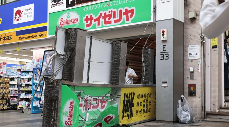 A store sign of a restaurant is seen fallen on the ground after an earthquake in Kumamoto in the Kyushu island, southern Japan, Tuesday, July 28, 2026. (Kyodo News via AP)