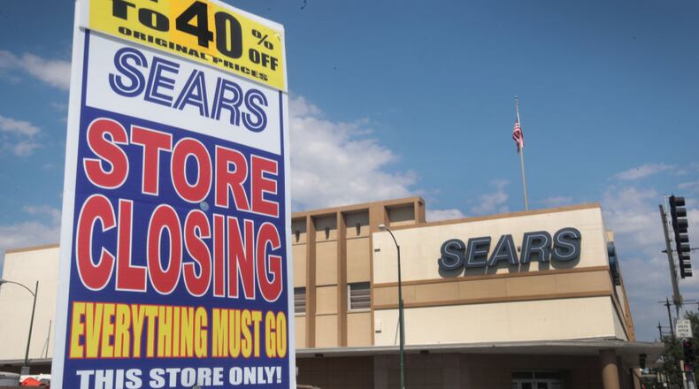 CHICAGO, IL - JULY 07: A worker holds a sign announcing a store-closing sale outside the 60-year-old Sears store in the Galewood neighborhood on July 7, 2017 in Chicago, Illinois. When the store closes, only one Sears store will remain in Chicago, the home of the company's first store and former headquarters of the retail giant. Today Sears Holdings, the parent company of Sears and Kmart announced it would be closing another 43 stores beyond those previously scheduled for closing. The closings will bring Sears' store count to nearly half of what it was five years ago. (Photo by Scott Olson/Getty Images)
