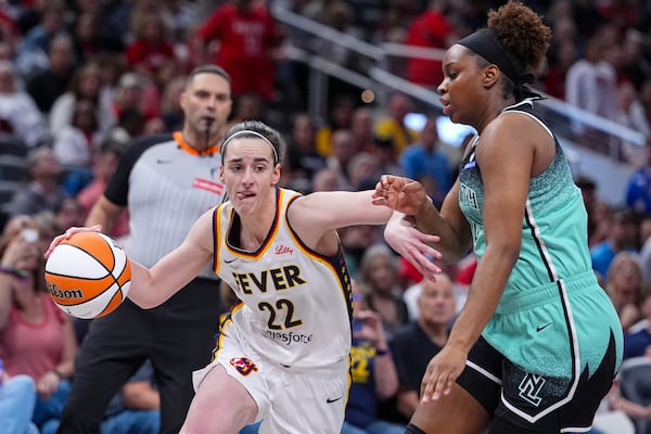 Indiana Fever guard Caitlin Clark (22) drives on New York Liberty forward Kennedy Burke (22) in the second half of a WNBA basketball game in Indianapolis, Saturday, May 24, 2025. (AP Photo/Michael Conroy)