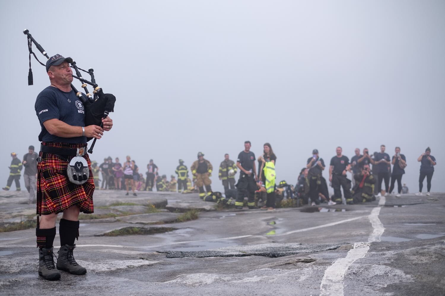 Henry County Cpt. Travis Miller plays the bagpipes atop Stone Mountain on Sunday morning, Sept. 11, 2022, during the annual remembrance of the 9/11 terrorist attacks. (Photo: Ben Gray for The Atlanta Journal-Constitution)