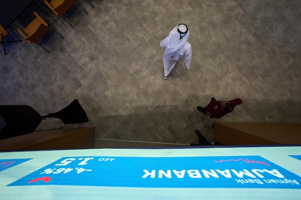 An Emirati walks into the Dubai Financial Market in Dubai, United Arab Emirates, Monday, April 7, 2025. (AP Photos/Fatima Shbair)