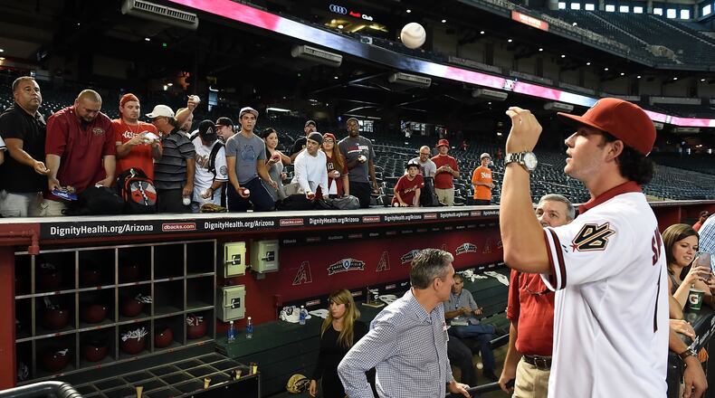 Dansby Swanson of the Arizona Diamondbacks, the first overall pick in the 2015  Major League Baseball draft, signs autographs prior to a game against the Miami Marlins at Chase Field on July 20, 2015 in Phoenix, Ariz.