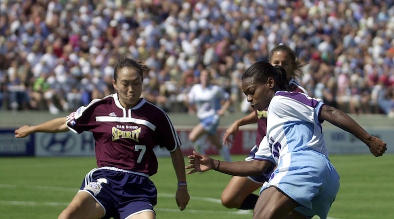 Atlanta Beat's Charmaine Hooper manuevers against the defense of San Diego Spirit's Wen Lirong during first half action from their WUSA game Sunday July 29, 2001, in San Diego.