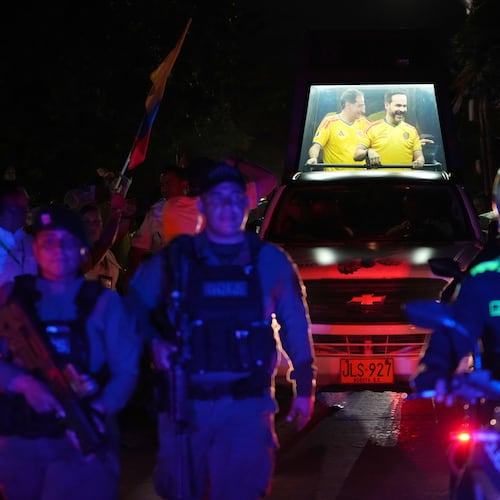 Presidential candidate Abelardo de la Espriella of the opposition Defenders of the Motherland movement and his vice-presidential running mate, Jose Manuel Restrepo, ride in a bulletproof booth toward a celebration rally after election results showed him leading in Barranquilla, Colombia, Sunday, June 21, 2026. (AP Photo/Rodrigo Abd)